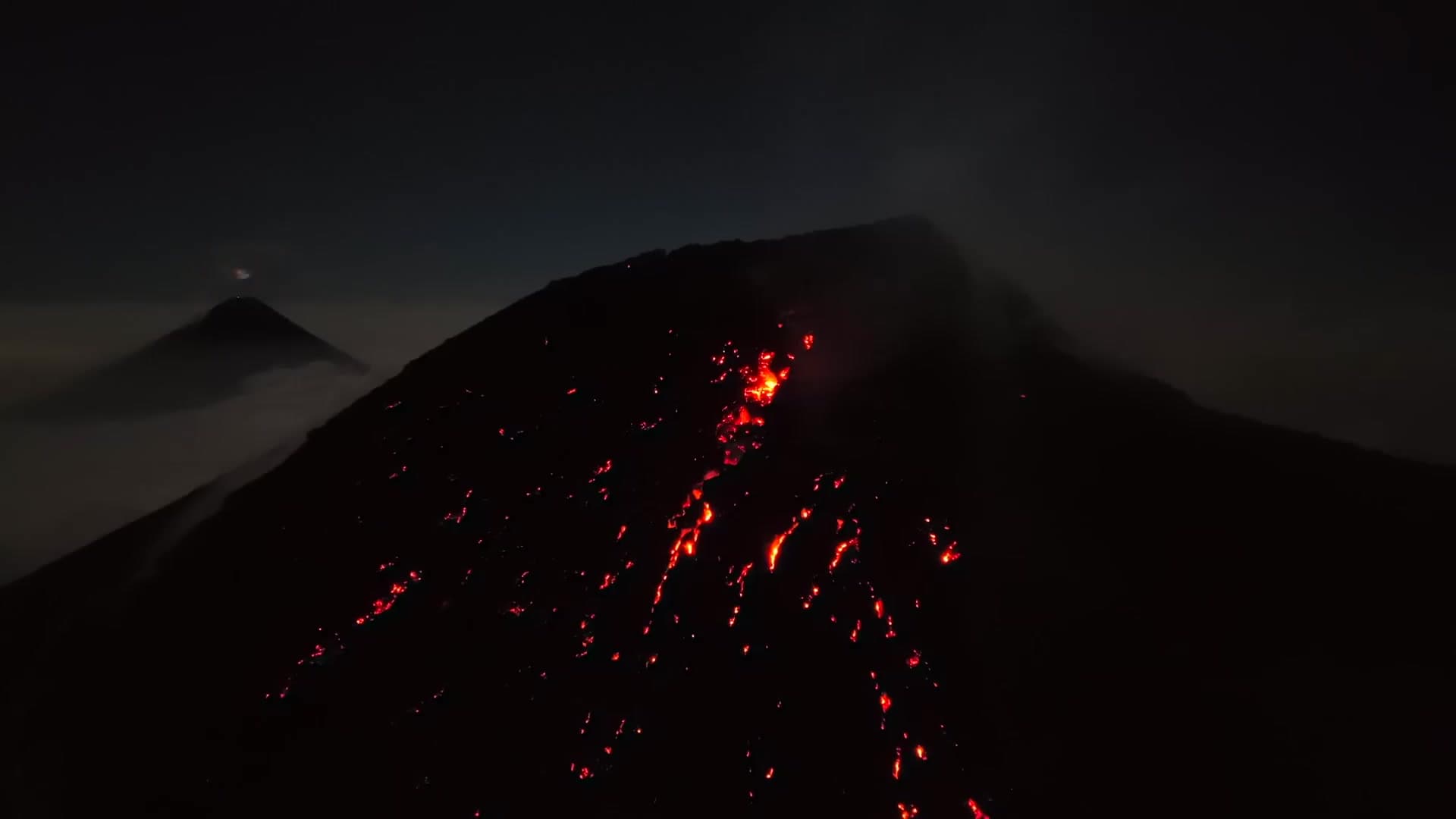 Volcán de Fuego erupting at night, seen from Acatenango's summit